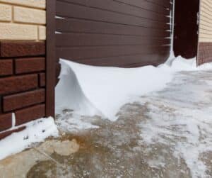 snow drift in front of garage door